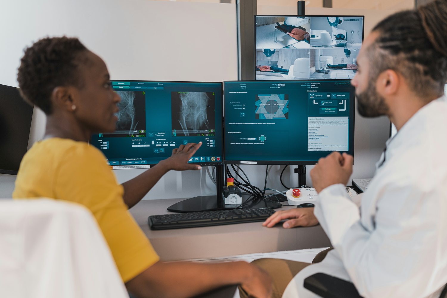 Two clinical experts reviewing AI-supported medical imaging together at a workstation